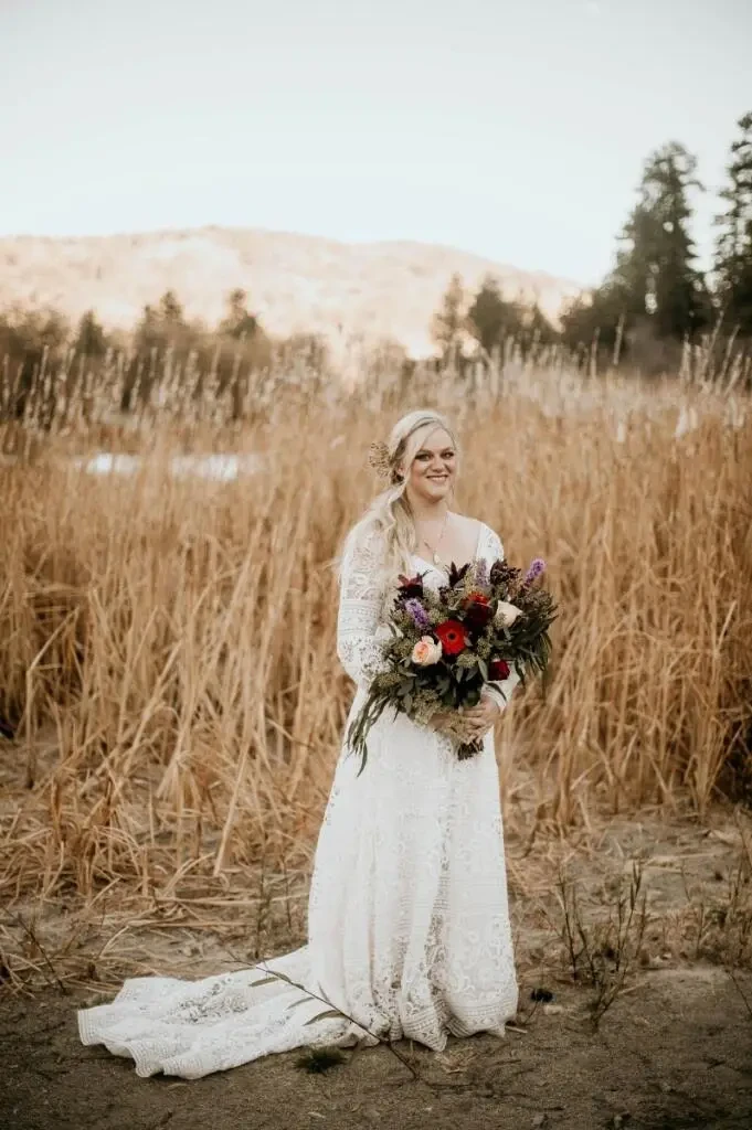 Model wearing a white gown with flowers