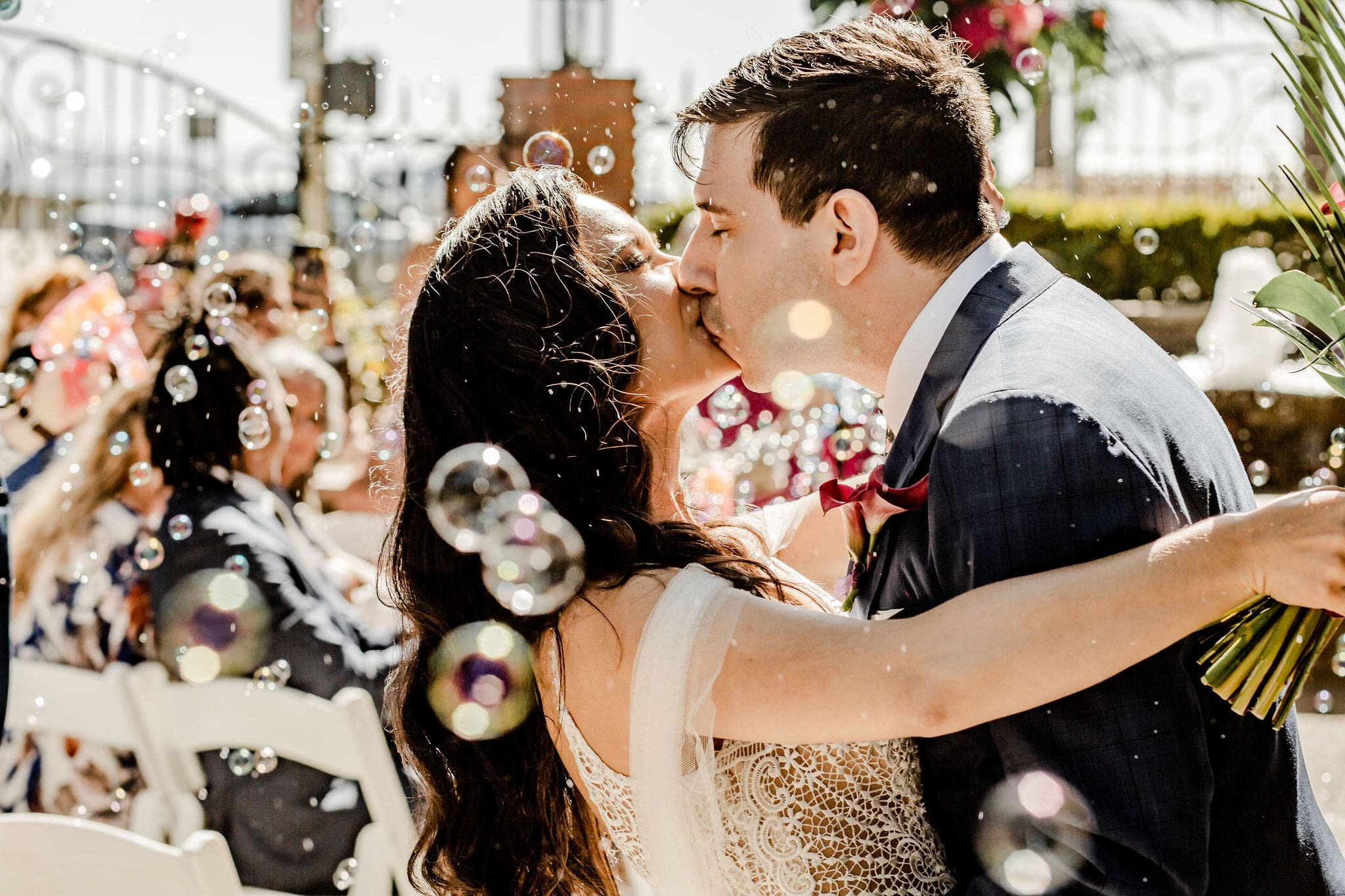 Kissing couple wearing a white gown and a black suit
