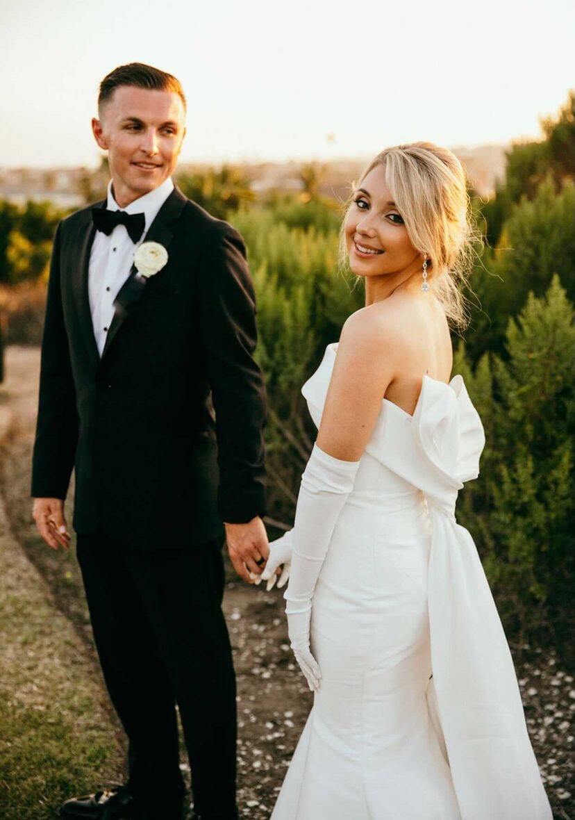 Сouple wearing a white gown and a black suit