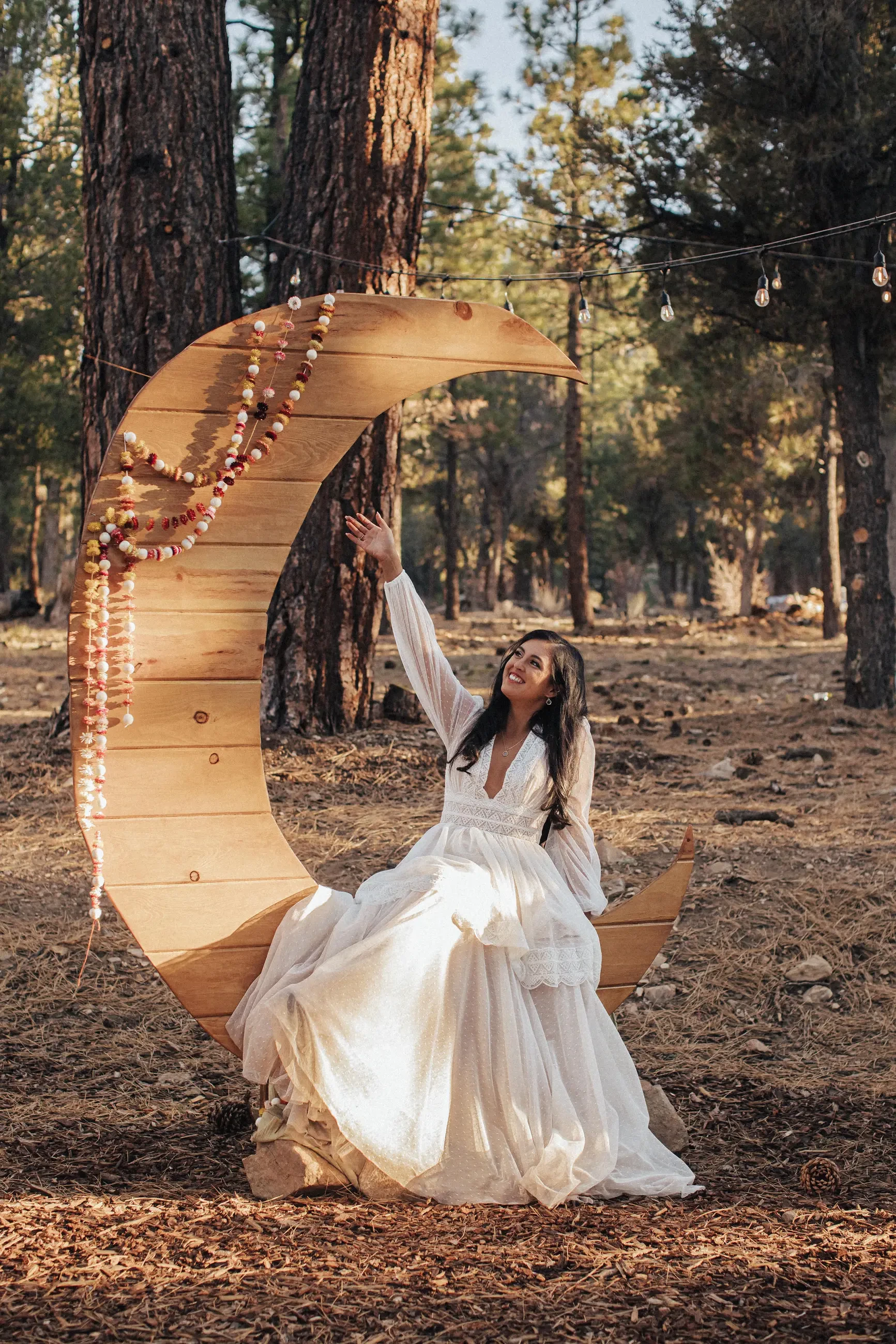 Model wearing a bridal dress on a swing