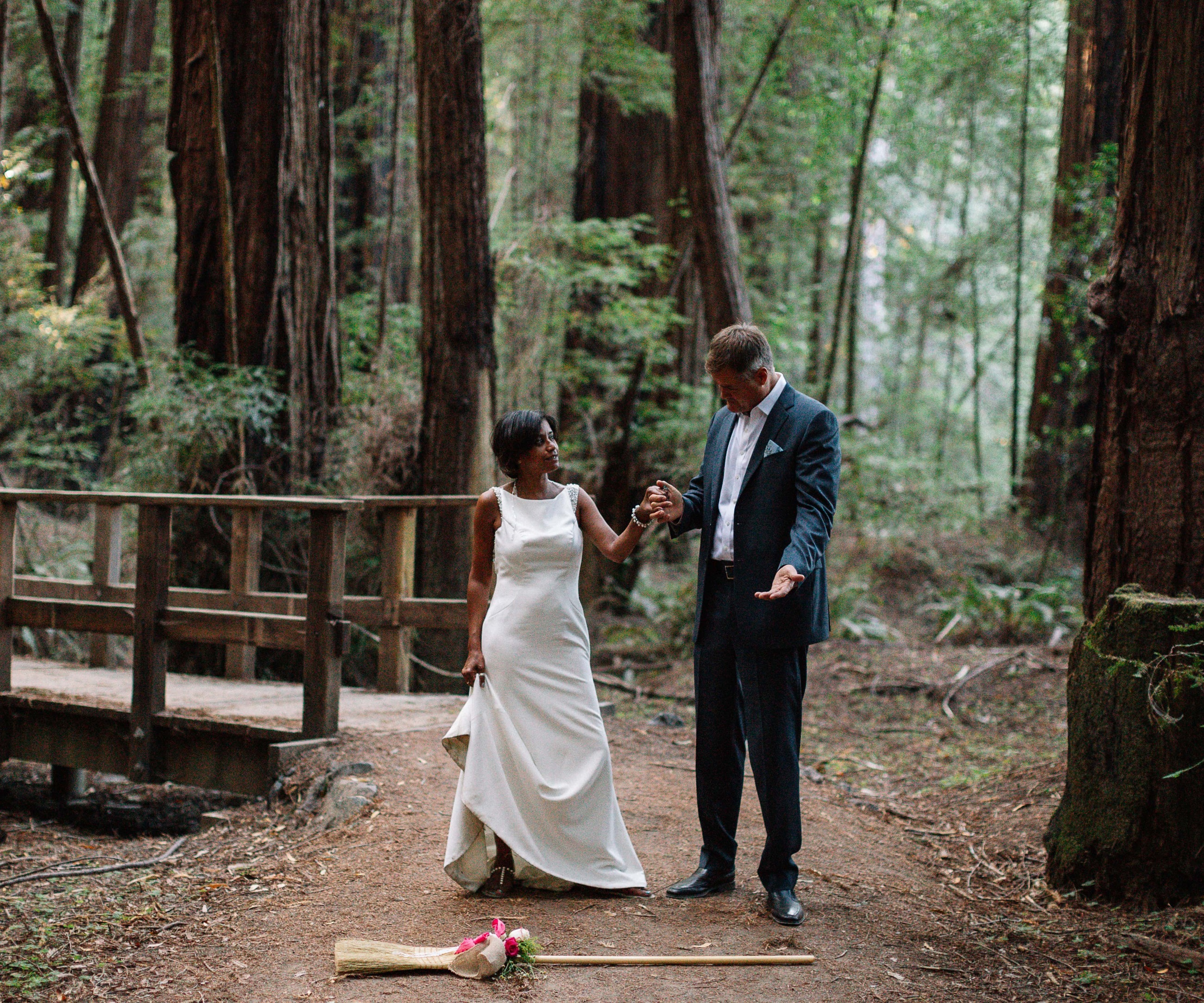 Сouple wearing a white gown and a black suit. Mobile image