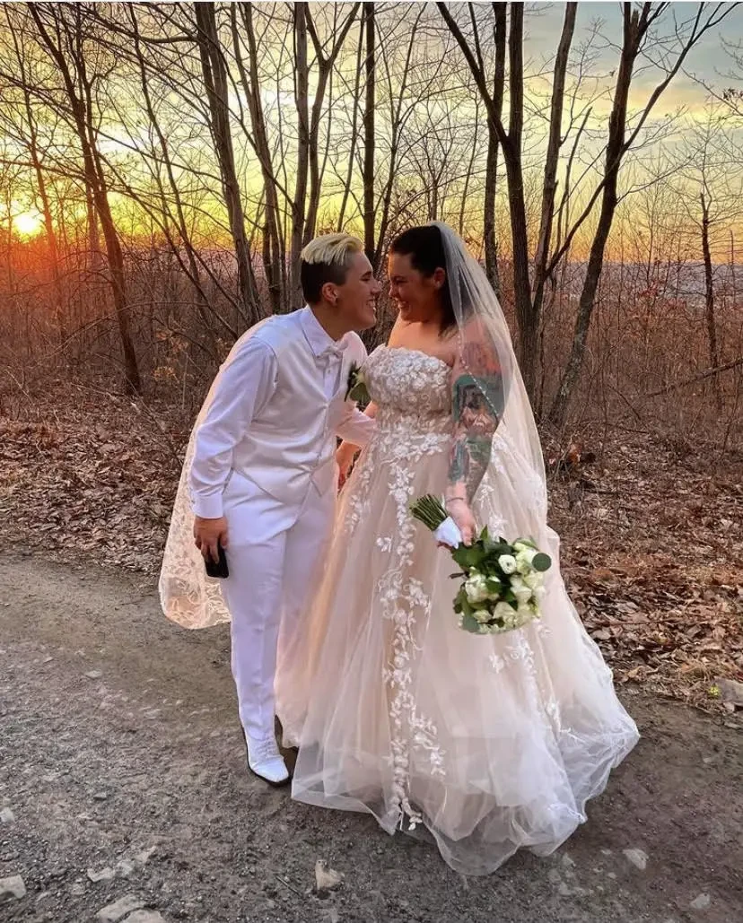 Сouple wearing a white gown and a white suit