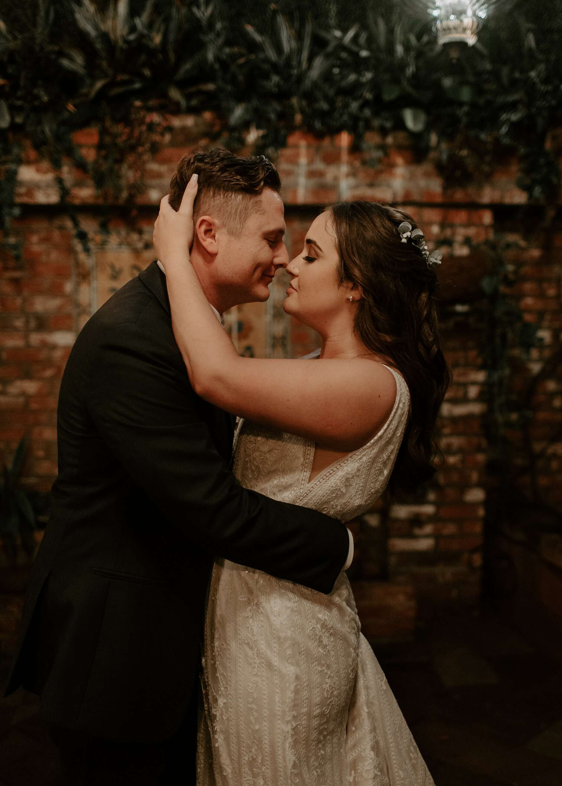 Сouple wearing a white gown and a black suit
