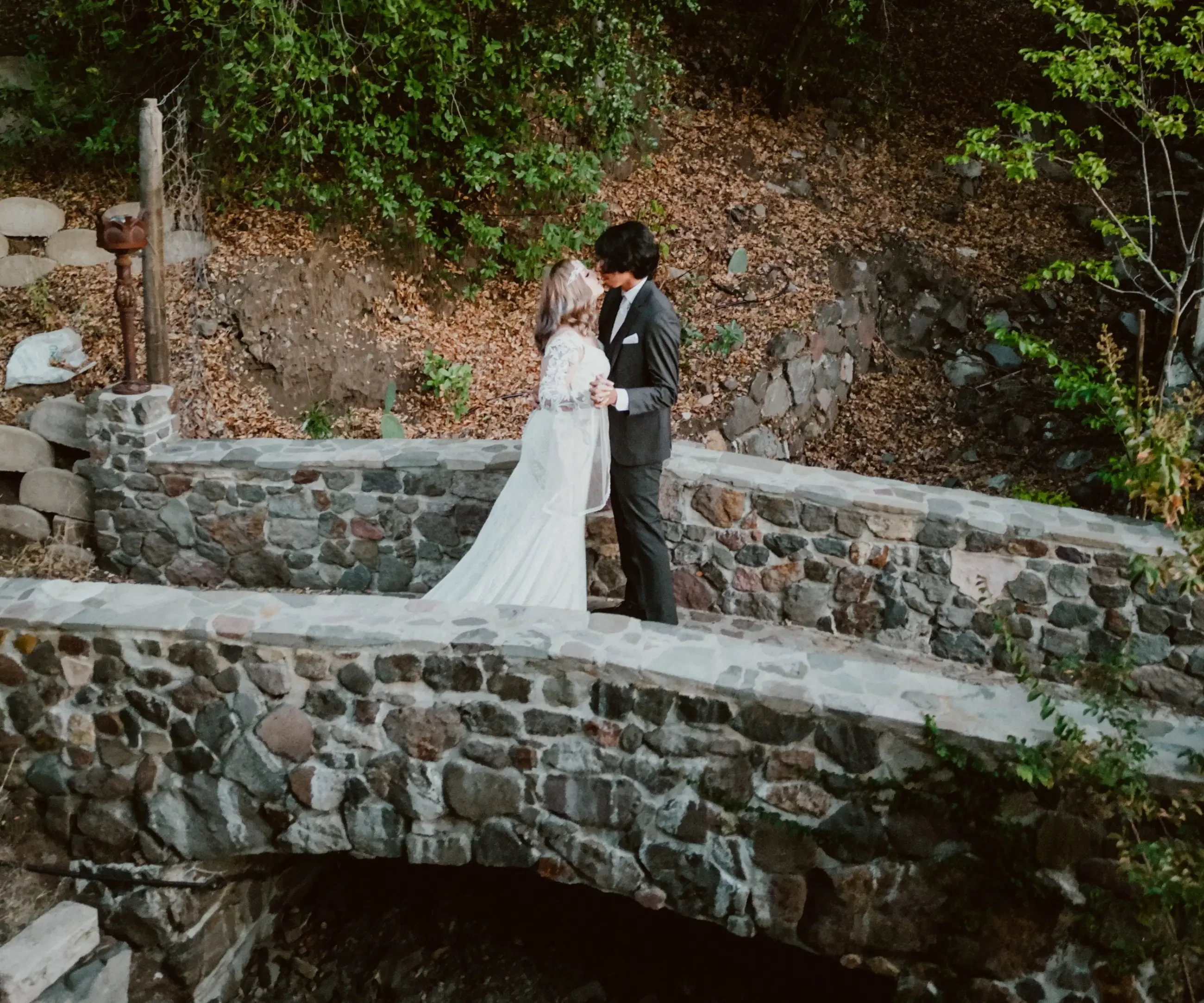 Сouple wearing a white gown and a black suit. Mobile image