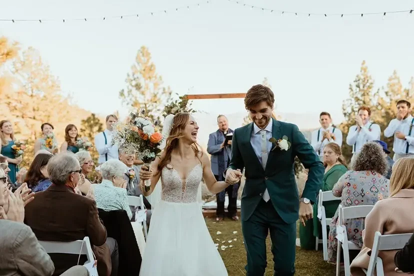 Сouple wearing a white gown and a black suit