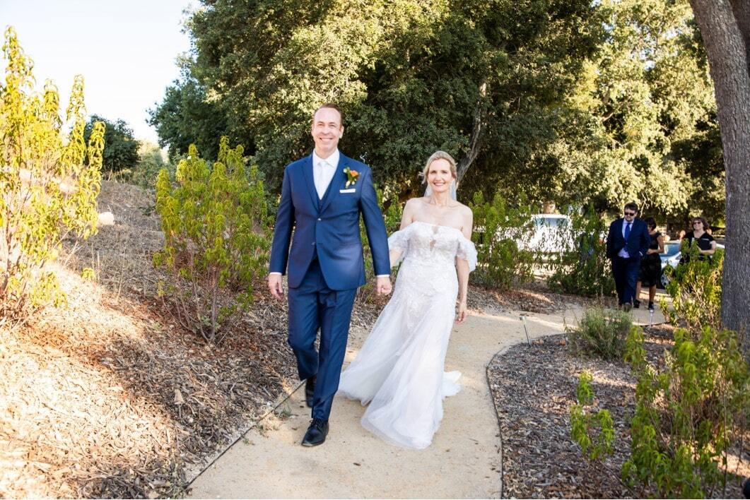 Сouple wearing a white gown and a blue suit